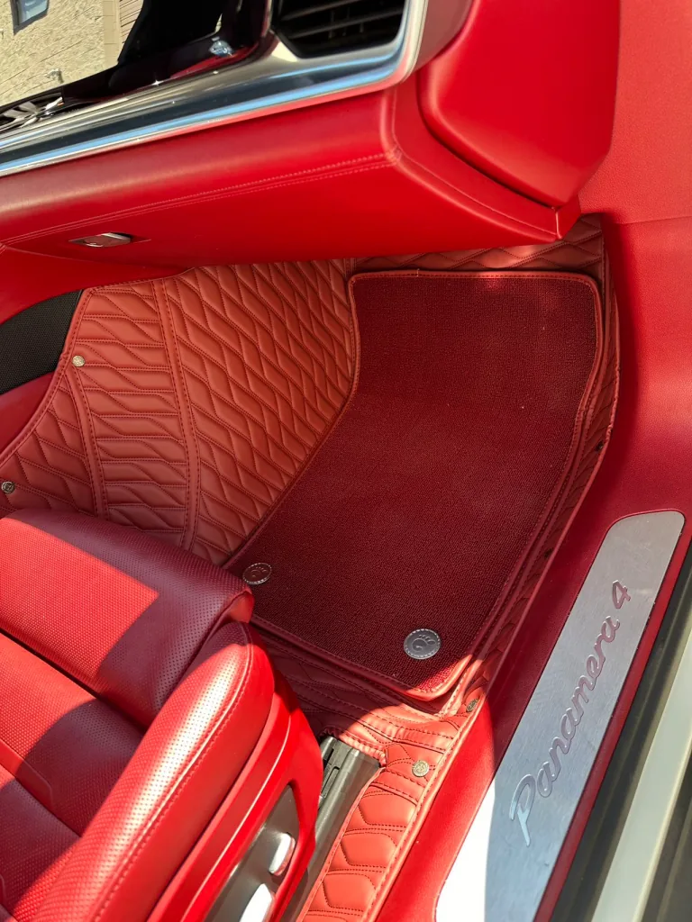 Red double layer car floor mats in a Porsche Panamera 4 with red interior