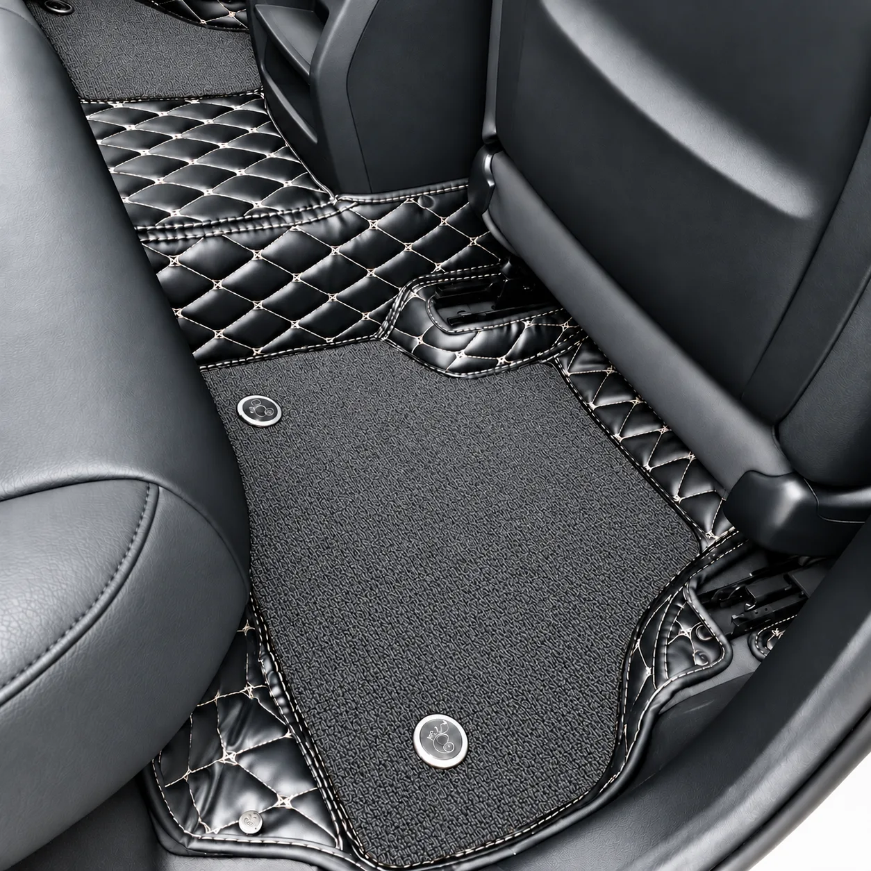 double layer car floor mats in rear footwell, black diamond quilted with grey carpet upper layer