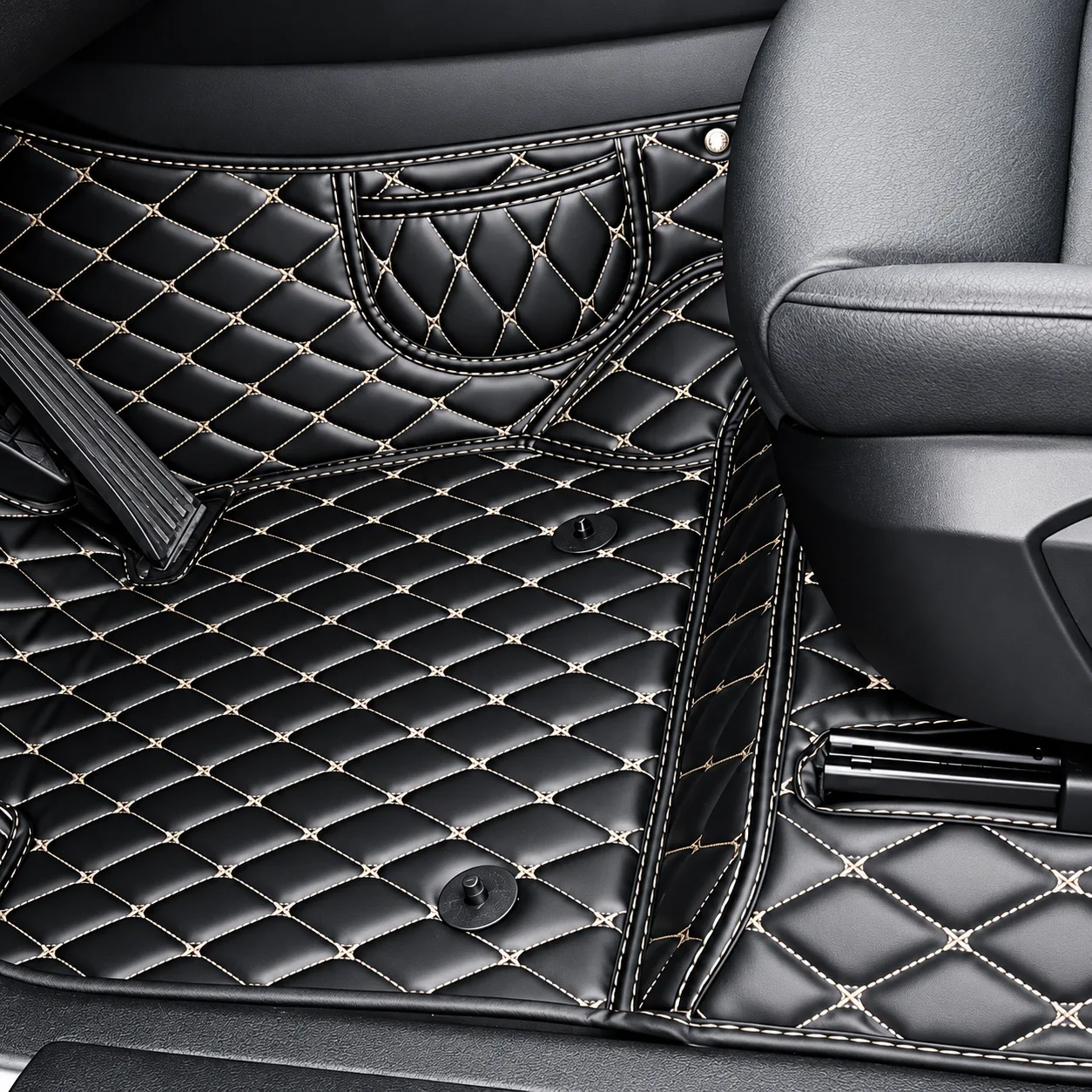 black diamond quilted car floor mats with beige stitching, installed in driver area