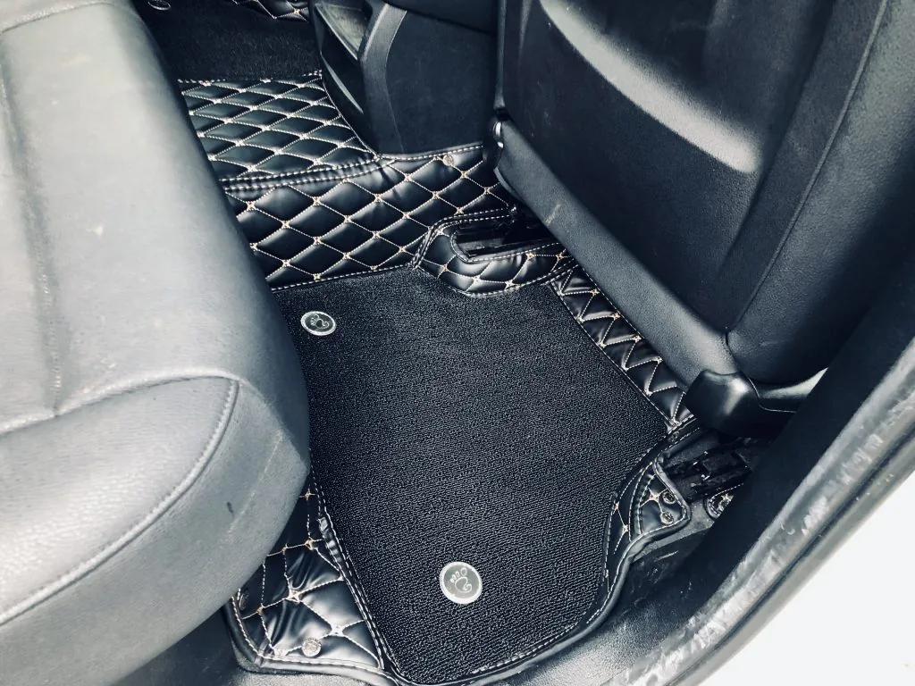 Black double layer car floor mats with quilted leather border and carpet top layer, rear row