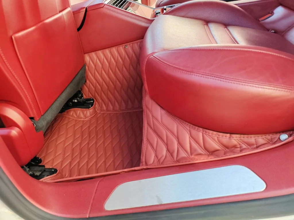Red quilted leather car floor mats with diamond pattern in a red leather interior
