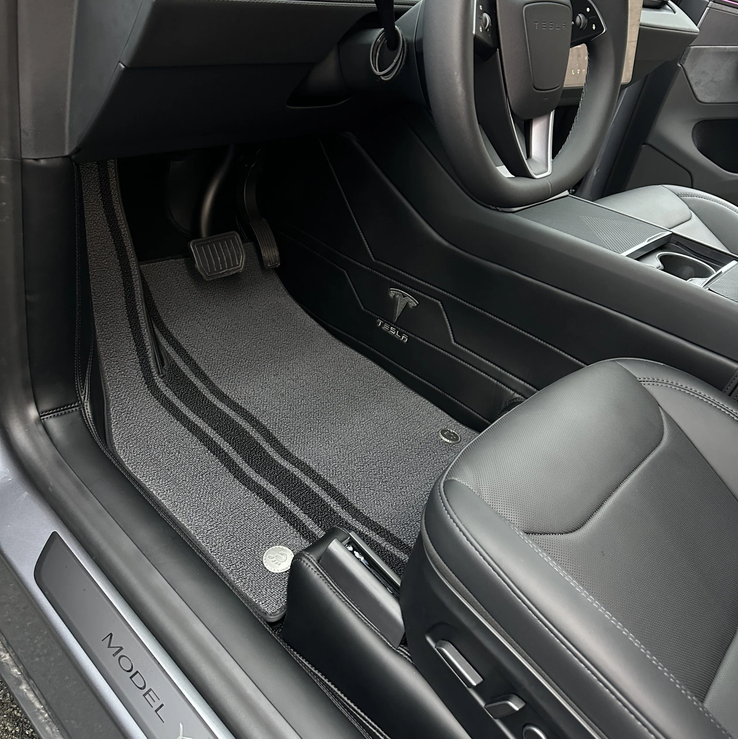 real customer photo of custom black car floor mats installed in Tesla Model Y, driver side