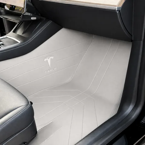 pale grey custom car floor mats installed in Tesla, real photo with Tesla logo embroidery